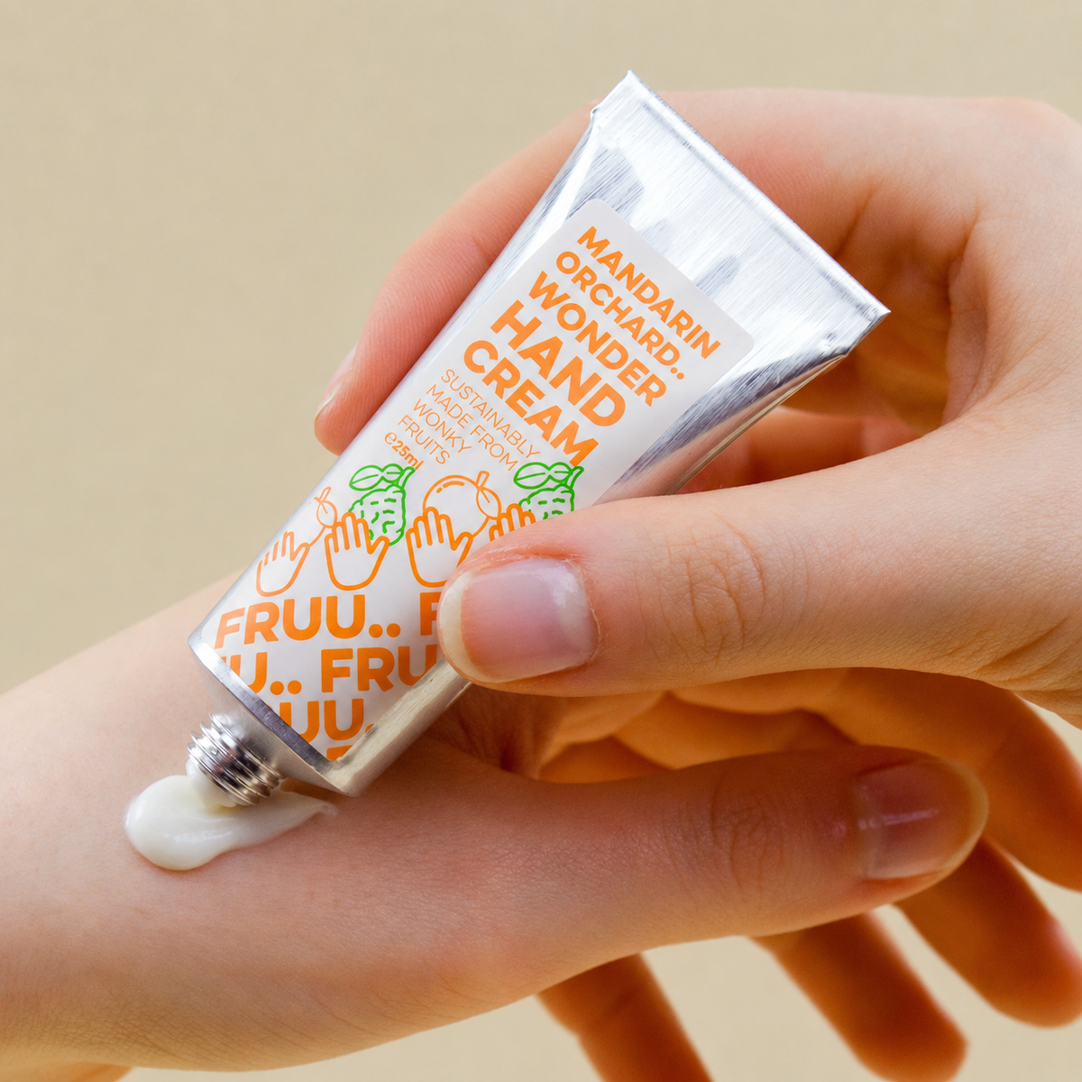 Mandarin Orchard Wonder Hand Cream being applied to a hand